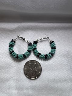 Teal and black small beaded hoop earrings Black Small Hoop Earrings With Ear Wire, Black Beaded Round Earrings, Handmade Black Beaded Small Hoop Earrings, Black Beaded Small Hoop Earrings As Gift, Handmade Black Dangle Hoop Earrings, Handmade Black Hoop Jewelry, Small Black Hoop Earrings For Jewelry Making, Nickel-free Black Small Hoop Earrings, Black Beaded Round Hoop Earrings