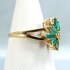 "IMPORTANT description is available following the details. Please, read on. Thank you. Material: 18K solid gold, natural brilliant cut diamonds, natural faceted navette emeralds Size: 5 3/4 size of the face of the ring 12mm x 12mm Weight: 2.5g Period: vintage Style: dinner, every day wear, birthday Provenance: an estate sale condition: very good (see description) Additional remarks: stamped with the owl marks plus the number 750 (inside the shank) N.b.: We guarantee the authenticity of our items Vintage Cocktail Ring, Fine Gold Jewelry, Solid Gold Ring, Vintage Cocktail, Solid Gold Rings, Multi Stone Ring, Multi Stone, Cocktail Ring, Brilliant Cut Diamond