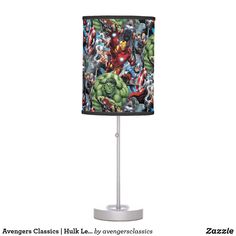 a lamp with an iron man and avengers pattern on the fabric shade is sitting on a metal stand