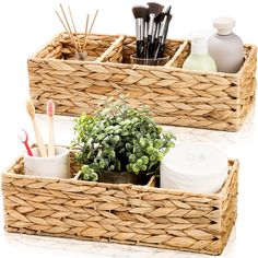 two wicker baskets with plants and toothbrushes in them on a white surface