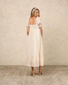 Our Chloe dress features puff sleeves with elastic openings and a ruffle detail, a full single tiered skirt, smocking at the back bodice, and a cinched bodice for a flattering cut. Featuring our 'iris' all-over print. Care: Machine wash cold, lay flat to dry Shell: 100% Cotton, Lining: 100% Viscose Noralee returns are eligible for exchange or store credit only. As these are special occasion items, we want to ensure that we only send customers new and unworn items. Returns for refunds are not acc Wooden Toy Shop, Western Shop, Chloe Dress, Outerwear Outfit, Tier Skirt, Infant Activities, Tiered Skirt, Puff Sleeves, Leotards