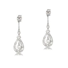 This lovely pair of earrings is Edwardian inspired, featuring intricate details in handcrafted platinum. Old mien cut diamonds are set along the drop of the earrings, surrounding the center diamond. The total approximate weight of these earrings is 2.00 carats. ✦ EARRING SPECIFICATIONS: Ring Material: Platinum Ring Era: Edwardian Era Stones: Diamond ✦ WHAT COMES IN YOUR SHIPMENT: - Your Engagement Ring - Quality Ring Box - Jewelry Cleaner - UGL Certificate ✦ WHY SHOP WITH US: - We've been in bus Exquisite Pierced Diamond Earrings For Formal Occasions, Exquisite Diamond Pierced Earrings For Formal Occasions, Fine Jewelry Bridal Earrings For Formal Occasions, White Gold Chandelier Earrings For Formal Occasions, Formal Bridal Fine Jewelry Earrings, Classic Formal Pierced Diamond Earrings, Art Deco Diamond Drop Earrings For Formal Occasions, Classic Formal Diamond Pierced Earrings, Classic Bridal Earrings For Evening