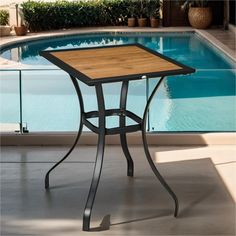 an outdoor table next to a swimming pool