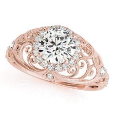 a rose gold engagement ring with an intricate filigree design and round diamond center