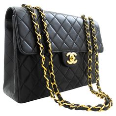 An authentic CHANEL Classic Large 11" Chain Shoulder Bag Flap Black made of black Lambskin. The color is Black. The outside material is Leather. The pattern is Solid. This item is Vintage / Classic. The year of manufacture would be 1996-1997. Conditions & Ratings Outside material: Lambskin Color: Black Closure: Turn Lock Hardware and chain: Gold-Tone Made in France Serial sticker: Attached Comes with: Dust bag, Box Bag Overall: 8 of 10 - The outside is in excellent condition with minimal signs o Black Channel Handbag, Big Bags For Women Chanel, Chanel Inspired Bags, Chanel Inspired Bags Handbags, Chanel 22k Bag, Vintage Chanel Bag 1stdibs, Chanel Inspired Purse, Chanel $95.00 Bag, Chanel 2016 Bag