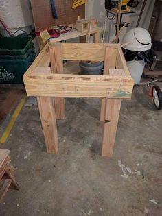 a table made out of wooden planks in a room with other woodworking tools