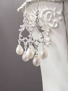 "Textured Front, Hollow Back These classic 18th century inspired chandelier earrings feature ornate silver plated brass connectors and teardrop shaped faux glass pearls. The connectors have a bright shiny silver finish. They have a detailed front and a hollow reverse side. (SEE PHOTOS) They are extremely lightweight yet sturdy. The earrings measure 2 1/2inches long from the longest dangle and hang from silver plated lever back ear wires. Perfect to complete a vintage inspired wedding look or rec Victorian Era Jewelry, Jane Austen Jewelry, 18th Century Jewelry, Dainty Pearl Earrings, Regency Jewelry, Bridgerton Style, Baroque Earrings, Teardrop Pearl Earrings, Bridal Art