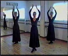 three women in long dresses are dancing on the floor with their hands up and arms raised