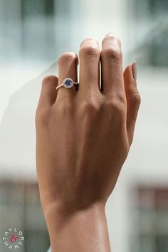 Woman's hand wearing Allure Rose Gold engagement ring with 1 carat Purple Sapphire and diamond halo and band from Taylor & Hart custom jewellery specialist. Made-to-order in London, UK. Engagement Ring Purple, Purple Sapphire Ring, Ring Purple, Bespoke Engagement Ring