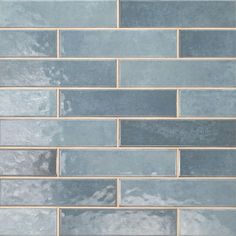 a blue brick wall with grey and white tiles