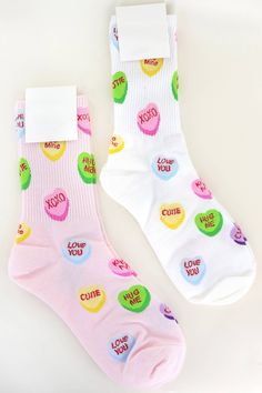 Valentine's Conversation Hearts Pattern Cotton Crew Socks are perfect for adding a touch of love to any outfit. The socks feature a variety of conversation heart messages such as "Be Mine" and "XOXO" in a colorful pattern. The socks are made of soft and comfortable cotton material, making them ideal for all-day wear. They are crew length and fit most foot sizes. These socks are perfect for Valentine's Day, but can also be worn any time of year to spread a little love and positivity. Show off you Valentines Socks, Cartoon Heart, Heart Socks, Converse With Heart, Pink Valentines, Heart Patterns, Crew Socks, Cotton Material, Online Boutique