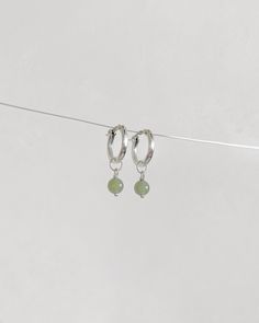 This pair of mossy-green dangle earrings will be your go-to piece. Shinny 6-7mm round nephrite, a variation of jade known for its exceptionally deep green hue, matches with minimal S925 Sterling Silver hoop earrings. ✿ Sold in a pair ✿ Material: 6-7mm /0.24-0.28in Natural Round Nephrite ✿ Finish: 15mm S925 Sterling Silver Huggie Hoops ✿ Approx. 1 inch in length and 0.6 inch in width ✿ Tarnish resistant, hypoallergenic, safe for sensitive skin Green Gemstone Dangle Hoop Earrings, Green Sterling Silver Hoop Earrings For May Birthstone, Dainty Green Round Hoop Earrings, Dainty Green Hoop Earrings, Nickel-free Green Sterling Silver Hoop Earrings, Green Sterling Silver Small Hoop Earrings, Minimalist Green Hoop Earrings With Ear Wire, Minimalist Green Hoop Earrings, Minimalist Green Moss Agate Jewelry