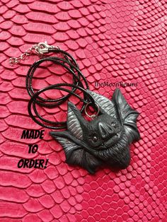 "MADE TO ORDER PROCESSING TIME 2-3 WEEKS It will be created for you, just like the one in the pictures, please allow slight variations due to the handmade nature of the piece, which makes each bat unique :) The new version of my classic Chubby Bat pendant Made by me using Black polymer clay,with silver accents(wings and ears) With Hematite eyes. It is 2\" wide and 2\" tall the back is flat It comes with a black cotton cord 18\" with a 2\" extension chain It comes in a gift box CARE: Please keep Bat Clay, Polymer Clay Pendants, Elf Jewelry, Painted Polymer Clay, Bat Pendant, Black Polymer Clay, Bat Jewelry, Creepy Christmas, Synthetic Dreadlocks