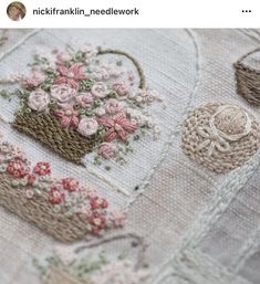 a close up of a piece of cloth with flowers and baskets on the back ground