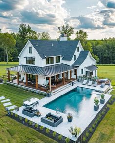 an aerial view of a house with a swimming pool and patio area in the foreground