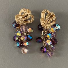 "These earrings are sumptuous and very glamorous, the dangling faceted crystal beads reminding me of grapes. These are beautifully made using quality materials. An unusual design. Rare find! Measure 2\" L x 1\" W. In excellent condition." Dark Purple Crystal, Crystal Bead Earrings, Purple Crystal, Unusual Design, Purple Crystals, Faceted Crystal, Bead Earrings, Dark Purple, Crystal Beads