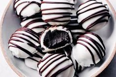 a white plate filled with chocolate covered donuts