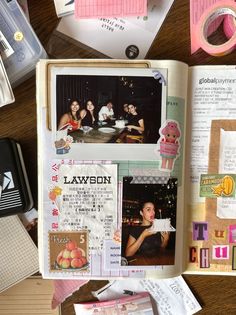 an open scrapbook with pictures and papers on top of it next to other items