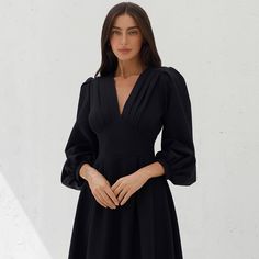 This elegant black midi dress combines timeless style with modern sophistication, making it a versatile choice for any special occasion. The dress features a flattering V-neckline with pleated detailing, voluminous puff sleeves, and a fitted waist, creating a classic yet contemporary silhouette. Made from premium dense crepe fabric, it offers both comfort and a luxurious feel. Whether you're attending a formal event, an evening party, or a sophisticated dinner, this dress will ensure you stand out with elegance and grace.  Elegant black midi dress with V-neckline and pleated bodice details. Features long puff sleeves for a refined, fashion-forward look. Crafted from premium crepe fabric, ensuring durability and comfort. Fitted waistline that accentuates your figure and creates a flattering Dress With Puff Sleeves, Classic Black Dress, Elegant Dinner, Pleated Bodice, Black Midi, Long Puff Sleeves, Crepe Fabric, Black Midi Dress, Dress Clothes For Women