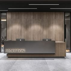 an office reception area with wood paneling and glass doors on the wall, along with two desks