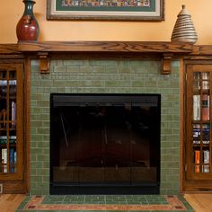 a fireplace with bookshelves and a painting on the wall