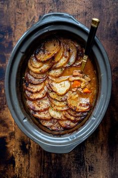 a pot filled with food on top of a wooden table