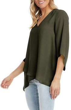 An elegant top of silky, lightweight crepe delivers elegant movement with its angled flare sleeves and fluttery asymmetrical hemline that dips low in back. 25 1/2" length (size Medium) V-neck Three-quarter sleeves Back yoke with gathering Crossover high/low hem 100% polyester Dry clean or hand wash, line dry Made in the USA of imported fabric Women's Clothing Flowy Spring Blouse With Asymmetrical Hem, Flowy Asymmetrical Hem Blouse For Spring, Flowy Blouse With Asymmetrical Hem For Spring, Spring Asymmetrical Silk Blouse, Chic Viscose Top With Asymmetrical Hem, Chic Viscose Tops With Asymmetrical Hem, Chic Flowy Blouse With Asymmetrical Hem, Asymmetrical Viscose Top For Spring, Formal Spring Blouse With Asymmetrical Hem