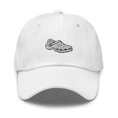 "Elevate your footwear fashion with our Croc Shoe Embroidered Cap. This unique cap features a detailed embroidery of the iconic Croc shoe design, making it a fun and distinctive addition to your collection. Crafted with precision and quality, this cap offers both style and comfort. Whether you're a Croc lover or simply seeking a quirky accessory, this cap is the perfect choice. Get your Croc Shoe Embroidered Cap today on Etsy to showcase your love for these unique shoes and make a bold fashion statement. Don't miss out on this stylish and one-of-a-kind cap! Dad hats aren't just for dads. This one's got a low profile with an adjustable strap and curved visor. * 100% chino cotton twill * Green Camo color is 35% chino cotton twill, 65% polyester * Unstructured, 6-panel, low-profile * 6 embroi Casual Snapback Baseball Cap With Appliqué Logo, Casual Baseball Cap With Appliqué Logo, Casual Dad Hat With Embroidered Logo And Flat Brim, Casual Baseball Cap With Embroidered Logo And Flat Brim, Streetwear Baseball Cap With Embroidered Logo, Casual Hat With Appliqué Logo And Curved Brim, Embroidered Baseball Cap With Visor For Streetwear, Casual Trucker Hat With Embroidered Logo And Flat Brim, Embroidered Visor Baseball Cap For Streetwear