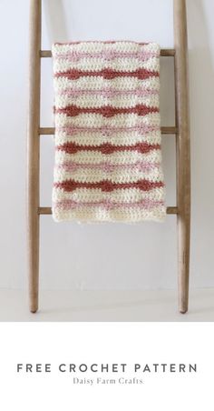 a crocheted blanket sitting on top of a wooden chair