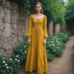 Get back to the majesty of times gone by with this dramatic, striking mustard yellow medieval dress, designed for Renaissance fairs, historical reenactments, and themed gatherings. The gown features long flowing sleeves and a flattering square neck, which greatly enhances the historic look. It comes in a rich mustard hue--all striking and eminently period-fitting for any purpose. Destroying the fallacy of her position, this gown speaks loudly to comfort and style by featuring a fitted bodice flo German Folk Dress, Vintage Long Sleeve Medieval Dress For Larp, Regency Style Long Sleeve Medieval Dress For Festivals, Medieval Long Sleeve Prairie Dress, Yellow Medieval Dress, Medieval Inspired Outfits, Fairytale Clothes, Victorian Cosplay, Costume Pirate