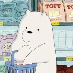 a large white bear sitting in front of a freezer filled with ice and food