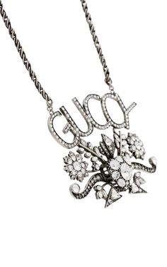 The Gucci GUCCY Crystal Necklace in Silver is crafted of aged, silver-tone metal in Italy. This crystal encrusted necklace features the GUCCY logo, a swirling flower design, a twist, and corded style chain. The back has the Gucci logo and delicate line work detailing. Silver GUCCY Crystal Necklace100% silver-tone metal Necklace, jewelryGUCCY logo Flower design Crystal encrusted Adjustable twist, corded chain Line work and Gucci logo on backLobster style clasp3.25" x 2.5" pendant Chain drop 15.5" Elegant Gucci Sterling Silver Necklace, Gucci Sterling Silver Necklace, Gucci Metal Chain Jewelry, Gucci Silver Sterling Silver Necklace, Gucci Silver Pendant Jewelry, Gucci Elegant Necklace With Logo Charm, Elegant Gucci Pendant Jewelry, Gucci Luxury Pendant Necklace, Gucci Silver Chain Jewelry