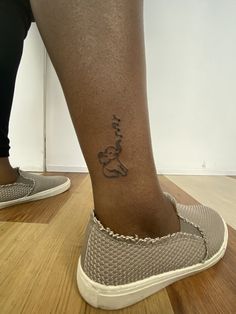 a woman's foot with a tattoo on her left leg and the word love written in cursive writing