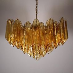 a yellow chandelier hanging from a ceiling