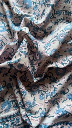 a blue and white fabric with flowers on it