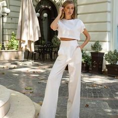 Elevate your summer wardrobe with this sophisticated two-piece linen set, featuring a chic crop top and high-waisted wide-leg pants in a stunning milk white shade. Perfect for warm weather, this breathable and stylish outfit is ideal for both casual and dressy occasions.          Material: 100% linen, offering a natural and breathable feel        Color: Milk white, a versatile and timeless shade        Sizes: Available in XS, S, M, L to ensure the perfect fit        Minimalist design with a rela Chic Solid Color Spring Pant Set, Summer Solid Color High-waisted Pants Set, Solid Color High-waisted Pants Set For Summer, Solid High-waisted Pants Sets For Summer, Summer Sets With Solid High-waisted Pants, Summer Two-piece Wide Leg Bottoms, Chic Solid Two-piece Pant Set, Chic Two-piece Solid Pants, Chic Solid Sets With Straight Pants