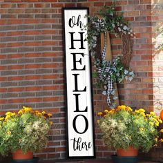 a sign that says oh hello there with flowers in front of it