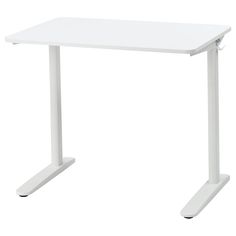 a white computer desk sitting on top of a table