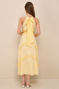 Take your look to a whole new level of lovely with the Lulus Perfectly Serene Light Yellow Eyelet Ruffled Tie-Back Midi Dress! Lightweight woven fabric, with darling eyelet embroidery throughout, shapes this summery dress with a modified halter neckline and a princess-seamed bodice. Cute side cutouts accent the fitted waist atop a tiered skirt composed of angled ruffles that continue down to the ankle-length midi hem. Turn around to reveal a sash tie that secures atop an alluring back cutout. Hi Chic Spring Ruffle Dress With Lace Trim, Feminine Yellow Dresses With Ruffle Hem, Sleeveless Ruffle Dress With Lace Trim For Spring, Spring Sleeveless Ruffle Dress With Lace Trim, Spring Halter Neck Dress With Lace Trim, Halter Neck Spring Dress With Lace Trim, Halter Neck Dress With Ruffle Hem For Day Out, Halter Neck Dress With Lace Trim For Brunch, Summer Midi Dress With Ruffles And Halter Neck