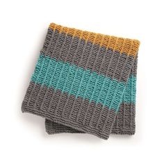 two gray and yellow knitted dishcloths sitting on top of eachother