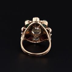 This vintage ring (circa 1960-1970) features assorted gemstones in 14k gold. The gemstones include garnet, zircon, emerald, sapphire, aquamarine, and chrysoberyl. The face of the ring measures 0.9 inches by 0.8 inches wide and is in very good condition with light surface wear. The ring is currently a size 6, but it can be resized free of charge. Materials: 14k gold, chrysoberyl, aquamarine, sapphire, emerald, zircon, garnet. Antique Multi-stone Round Emerald Ring, Antique Round Multi-stone Emerald Ring, Vintage Multi-stone Diamond Ring For Collectors, Vintage Multi-stone Diamond Ring Collectible, Vintage Multi-stone Ruby Ring In 14k Gold, Vintage Multi-stone Emerald Ring In 14k Gold, Vintage Multi-stone Sapphire Ring, Antique Green Multi-stone Ring, Heirloom Multi-stone Diamond Ring