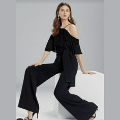 Our Ruffled Jumpsuit Is Effortlessly Glamorous For An Elegant Night Out Or Can Be Worn On Your Next Tropical Vacation 35" Inseam Arm Pit To Arm Pit 17” Waist 15” Cold Shoulder Sleeves Raw Edge Trim Self-Tie Belt 80% Polyester 14% Viscose 6% Elastanerecommended Care: Dry Clean Only Made At Our Own Factories In The Philippines Elegant Off-shoulder Sets For Spring, Elegant Off-shoulder Spring Sets, Black Summer Formal Set, Chic Off-shoulder Party Sets, Off-shoulder Jumpsuits And Rompers For Summer Formal, Summer Off-shoulder Jumpsuits And Rompers For Formal Occasions, Summer Evening Overall Pantsuit, Summer Evening Pantsuit Overall, Black Summer Evening Sets