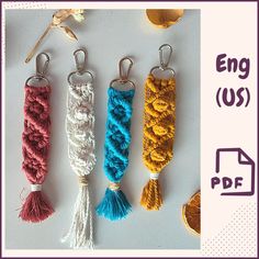 four key chains with tassels are shown in three different colors and the text eng us