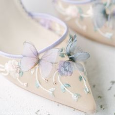 a pair of shoes with flowers painted on them