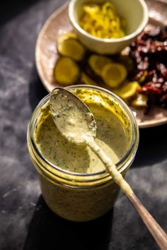 a spoon is sitting in a jar next to some food