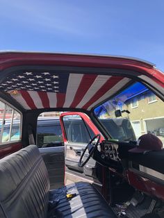 the interior of a red truck with an american flag painted on it's side