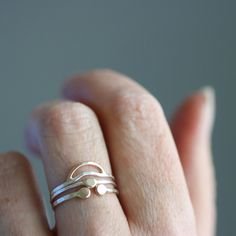 Three of my favorite night sky inspired rings combined for you in this pleasingly curated arrangement. Perfect for the nature girl who wants to make a dainty, subtle set to accompany you everywhere you go. It's also a great for those who get overwhelmed by all of the stacking ring options, and want to simplify the process. This stack is comprised of three separate rings, a Crescent Moon Ring (top), a North Star stacker (middle), and a Beta Lyrae Ring (bottom). Available in sterling silver, or sterling with recycled 14k yellow gold details. All Rebecca Haas Jewelry is handcrafted by me in my Southern Vermont Studio from recycled and ethically sourced materials. Minimalist Stackable Engraved Open Ring, Celestial Style Stackable Open Ring, Celestial Style Sterling Silver Stackable Rings, Minimalist Silver Stackable Open Rings, Silver Adjustable Moon Stackable Rings, Crescent Moon Ring, Moon Ring, Nature Girl, Gold Details