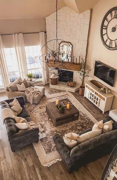 a living room filled with lots of furniture and a flat screen tv mounted to the wall