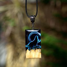 "Wooden HOWLING WOLF necklace for women. Wood resin pendant necklace. GLOW in the dark. Resin art jewelry. ♥ This item is handmade, so each piece is unique. The piece you receive will be based on this design and very similar to photos. ♥♥ Please see the current discounts in the shop announcement: https://www.etsy.com/shop/TSMDecorations Unforgettable Exclusive Birthday Gift. Handmade from Australian BROWN MALLEE burl wood and clear art resin.  Male or female pendant with a Howling wolf on an ill Black Personalized Pendant Necklaces, Personalized Black Pendant Necklaces, Magical Black Jewelry For Gifts, Black Wolf Design Jewelry For Gift, Adjustable Hand Painted Black Necklace, Magical Black Necklace For Gift, Mystical Pendant Jewelry As Gift, Mystical Pendant Jewelry Gift, Handmade Magical Pendant Necklace