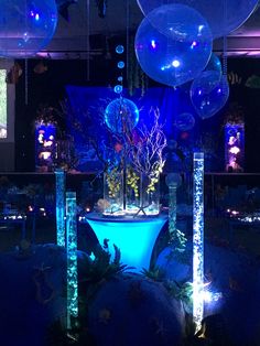 an indoor event with blue lighting and decorations